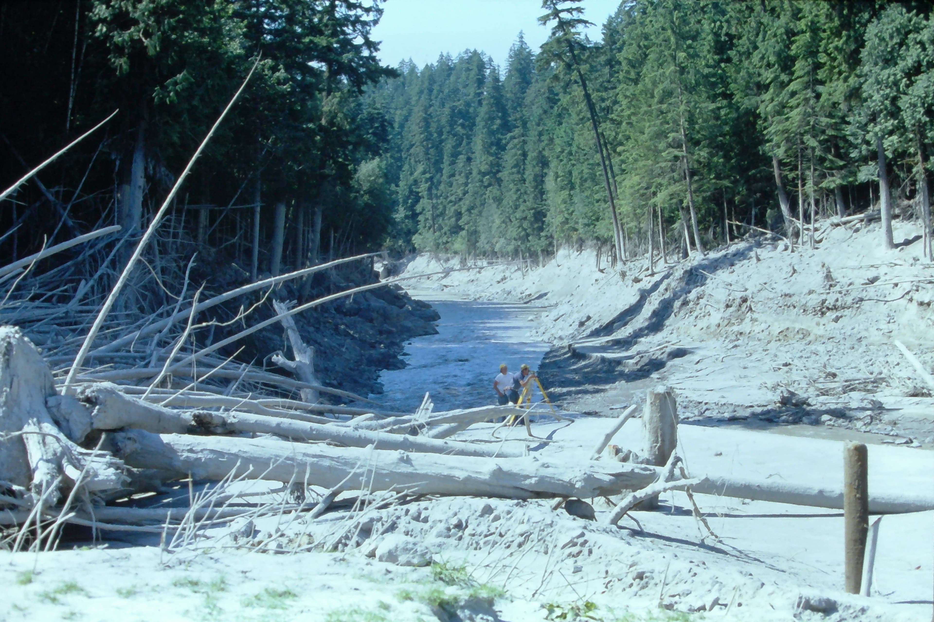 July 1980 Ron Lombard and Maury Miles surveying a cross section on the Main Fork Toutle River. USGS K. Tanner